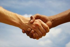 Two young businessmen shaking hands